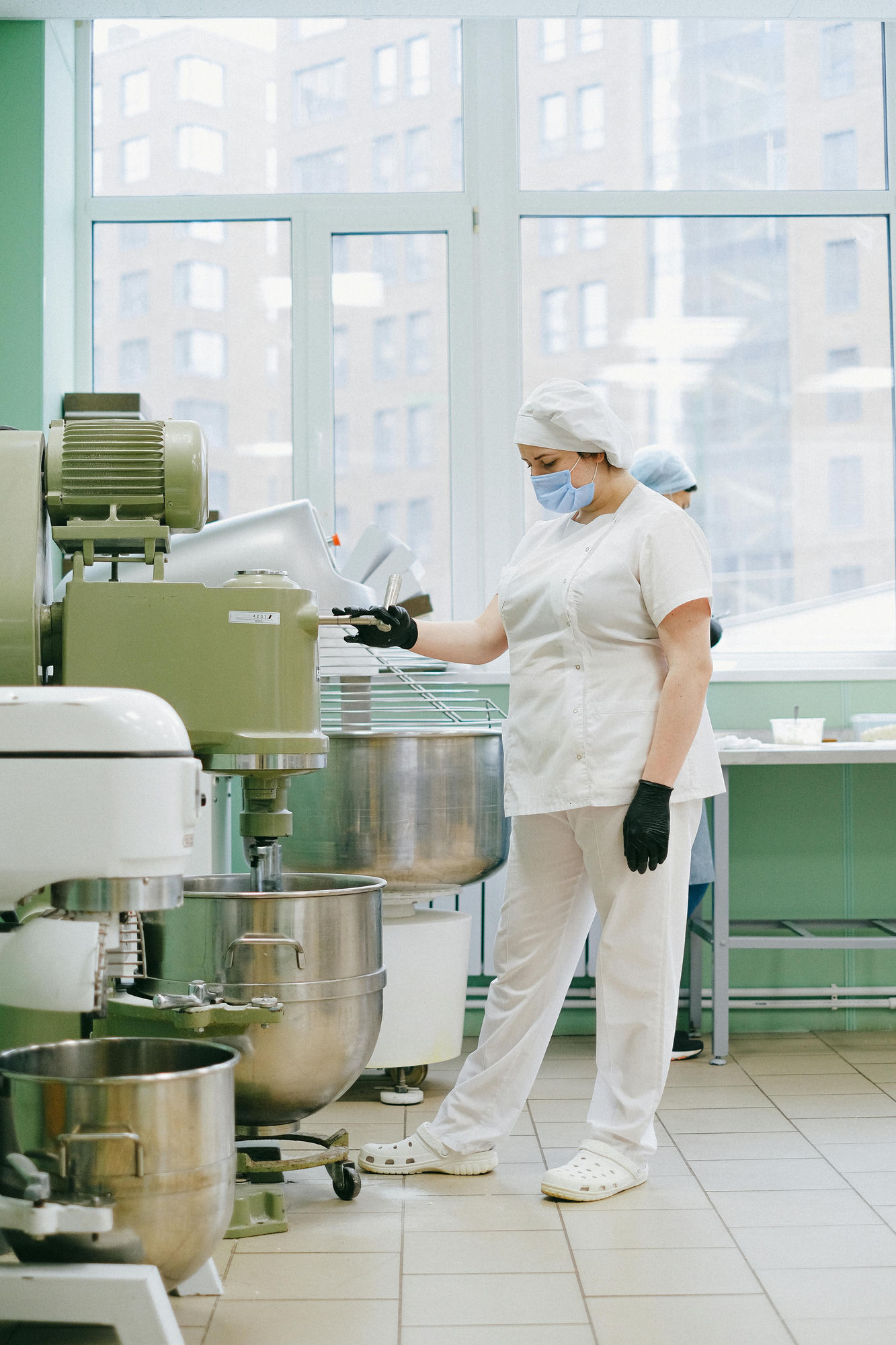 Worker in PPE at regulated production line